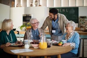 A staff member with residents at a care home. (Getty Images)