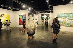 \Guests view art works presented by White Cube Gallery at the Miami Beach Convention Center as part of Art Basel Miami Beach on Dec. 9. (Sean Drakes/Getty Images)