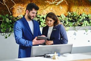 A hotel employee at the front desk. (Getty Images)