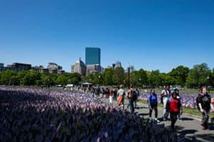 People tour a memorial with US flags set next to the Soldiers and Sailors Monument by the Massachusetts Military Heroes Fund for Memorial Day, in Boston on May 26. (Photo by Joseph Prezioso / AFP via Getty Images).