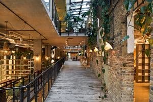 Corridor. The Fisheries, co-working space, London, United Kingdom. Architect: Guy Holloway Architects, 2019. (Photo by: View Pictures/Ed Reeve/Universal Images Group via Getty Images)