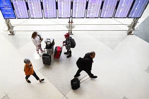 Airline passengers, some not wearing face masks following the end of COVID-19 public transportation rules, walk to flights in the airport terminal in Denver, Colorado, on April 19, 2022. (Getty Images)