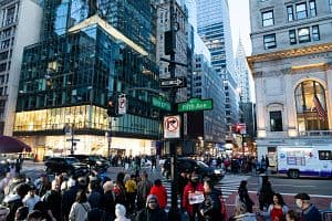 Shoppers cross 5th Avenue and West 42nd Street near the Bryant Park Winter Village Holiday Market in New York on Dec. 16. (Bloomberg/Getty Images)
