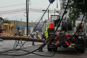 Hurricane Beryl made landfall in Houston on July 8, displacing many into hotels, which resulted in revenue per available room growth for the week ending July 13. Shown here, a lineman tends to fallen power lines days after the hurricane hit Houston. (Getty Images)